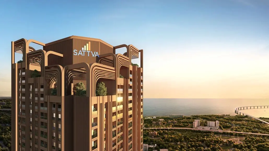 Modern brown high-rise with stacked curved arches and rooftop greenery, SATTVA logo, overlooking the coast at sunset.