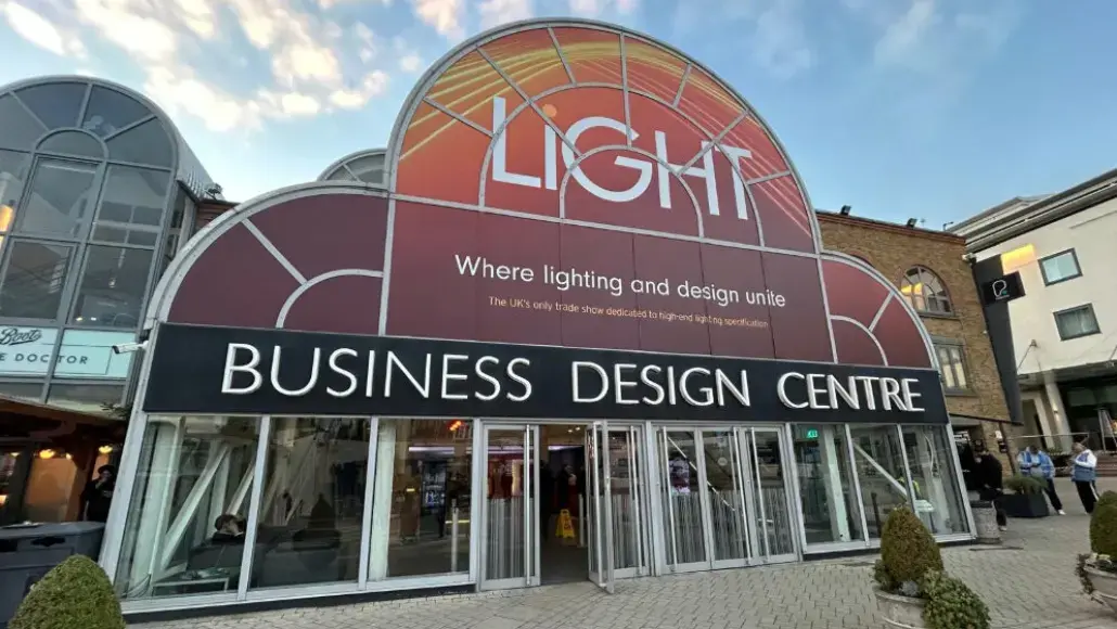 Front view of a glass-walled building labeled 'BUSINESS DESIGN CENTRE' with a large red sign 'LIGHT' above